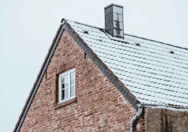 Roof of house covered by snow in winter